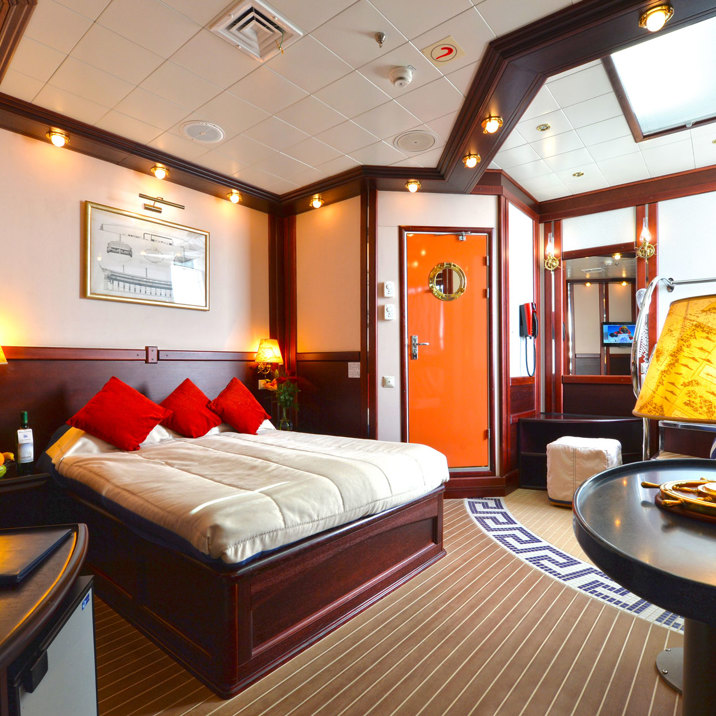 cabin interior with bed, TV, and coffee table