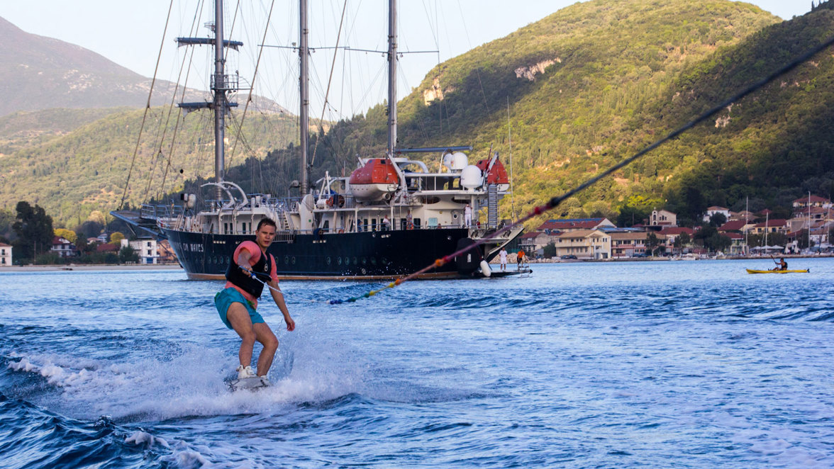 wakeboard with ship and kayak and island in the background