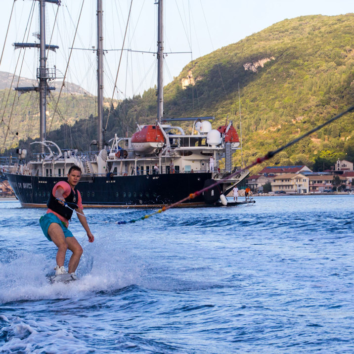 wakeboard with ship and kayak and island in the background