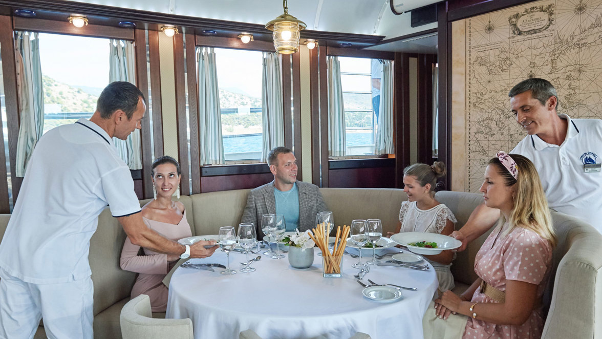 guests in the restaurant with waiters