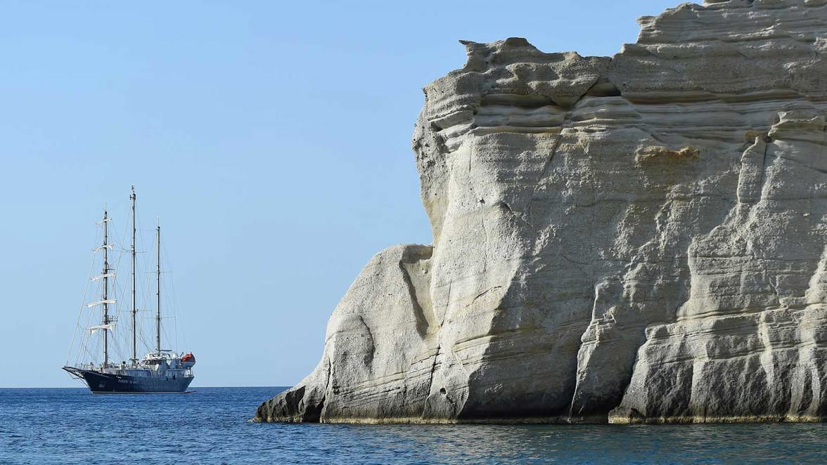 ship near high rocky coast 