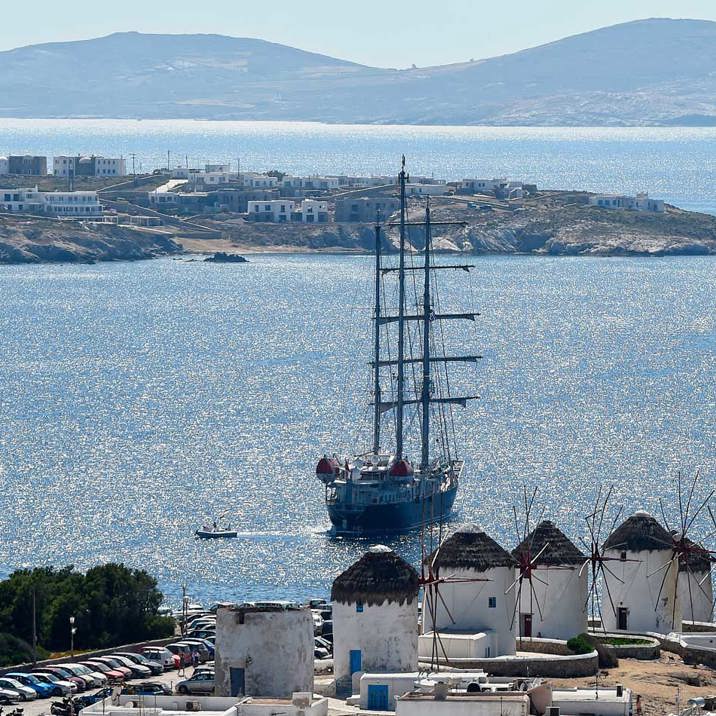 ship next to Mykonos coast and town windmills