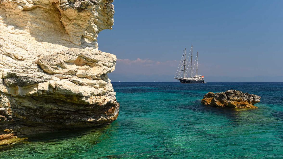 ship next to coast rocks