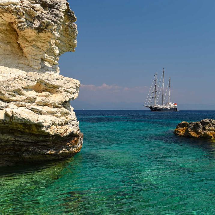 ship next to coast rocks