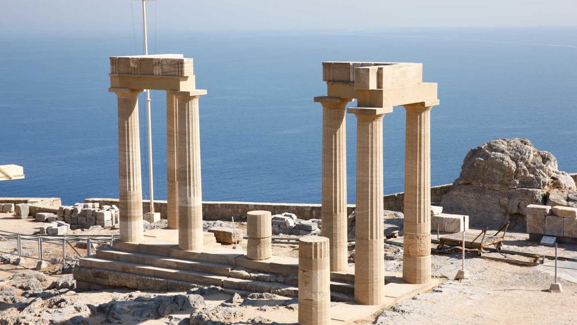 temple column ruins on rocky island hilltop