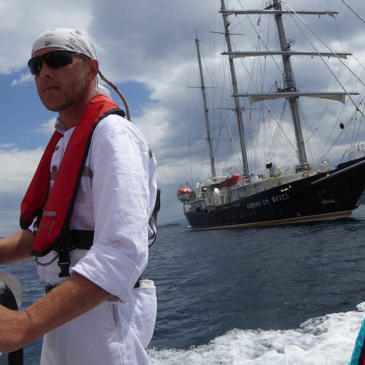 boatswain riding tender next to ship