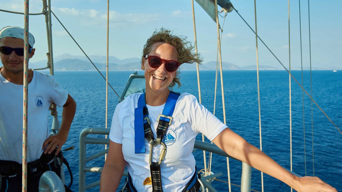 guest standing in mast nest smiling