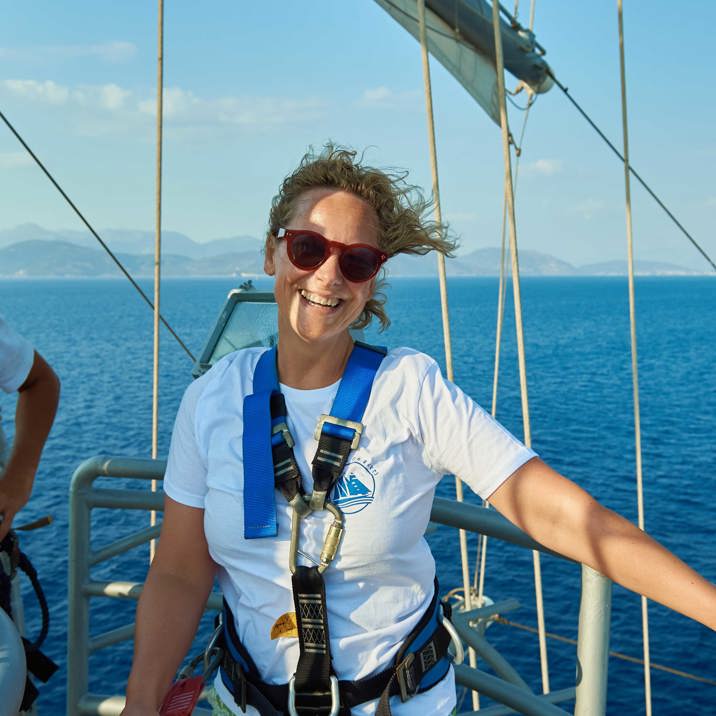 guest standing in mast nest smiling