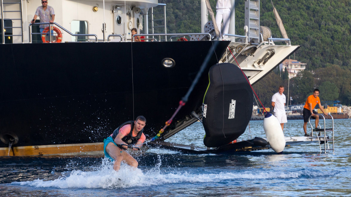 guest wakeboarding next to ship and apparel