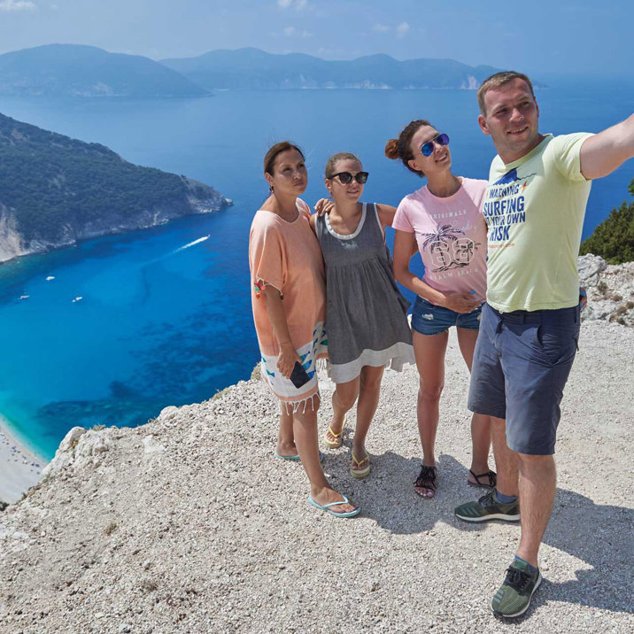 guest taking photo on hilltop near beach