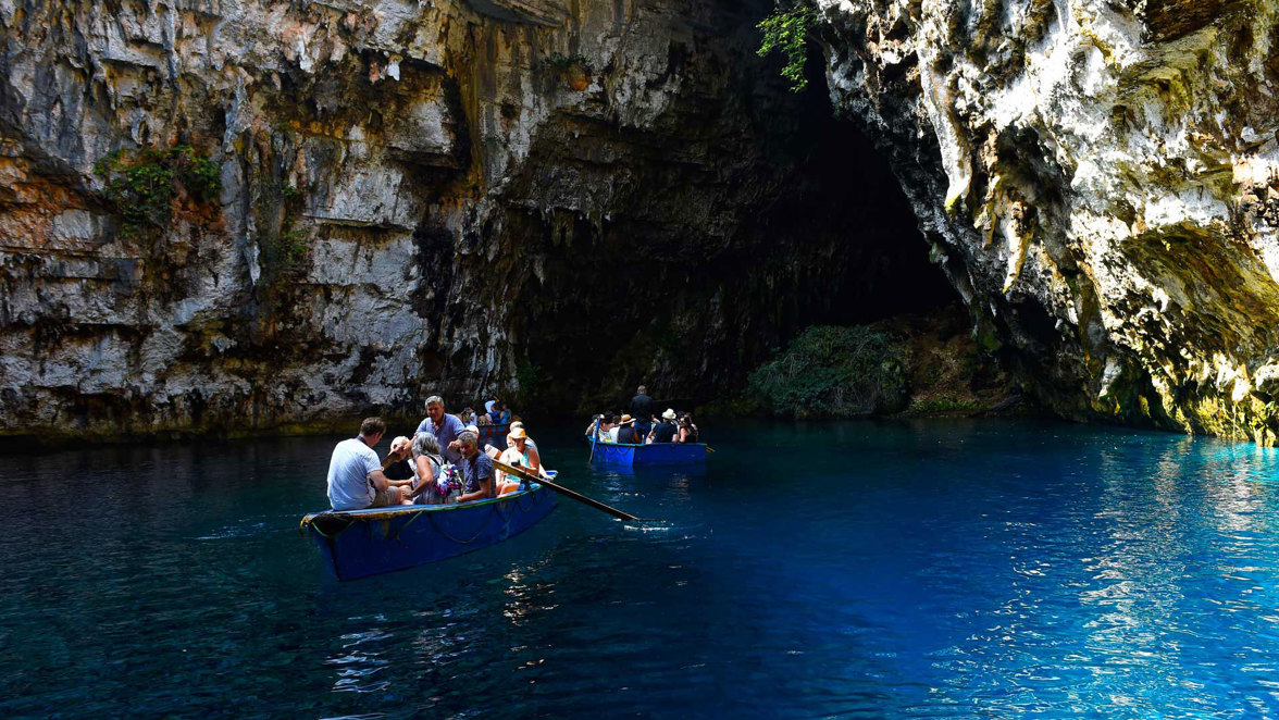 guests on boats netering coastal cave