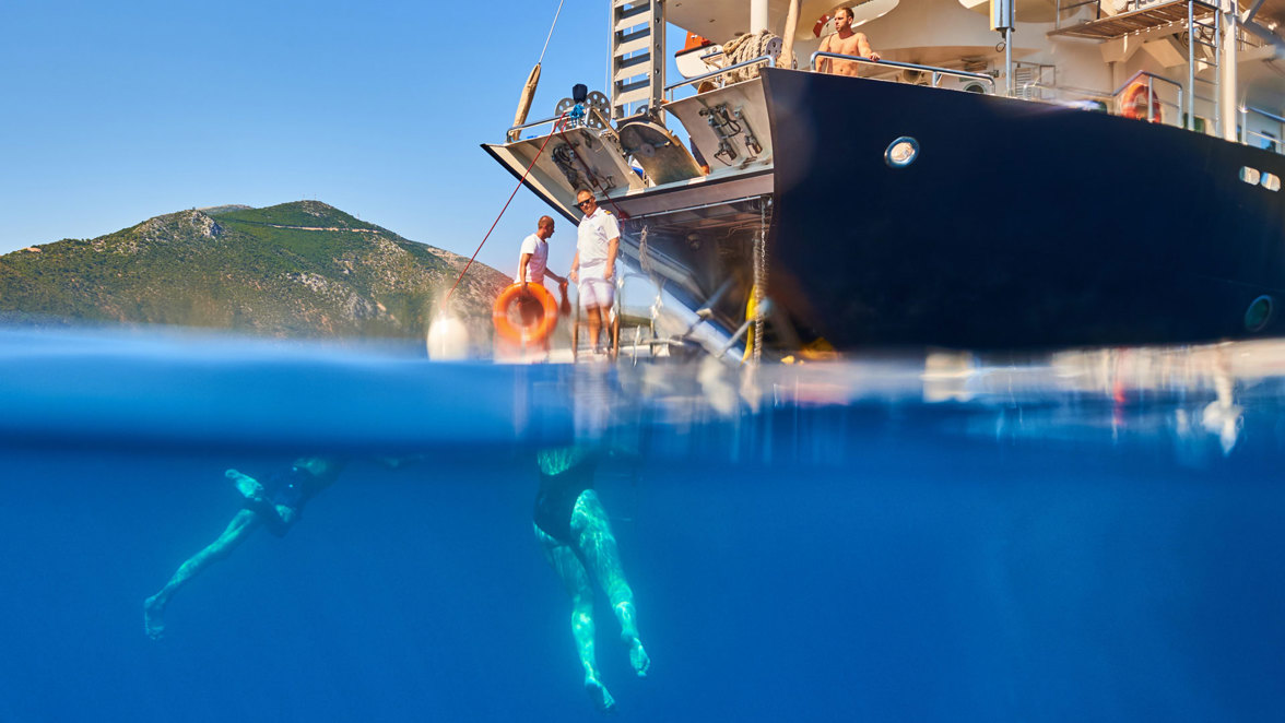 guests swimming next to ship's apparel
