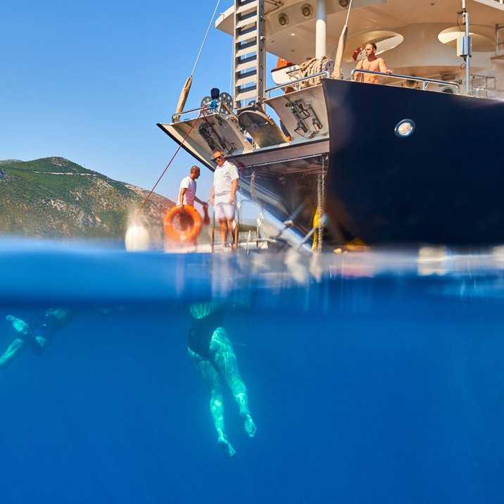 guests swimming next to ship's apparel