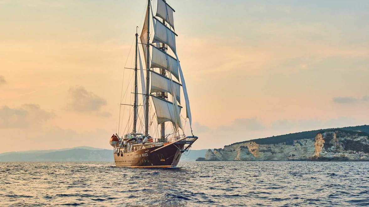 ship next to rocky island
