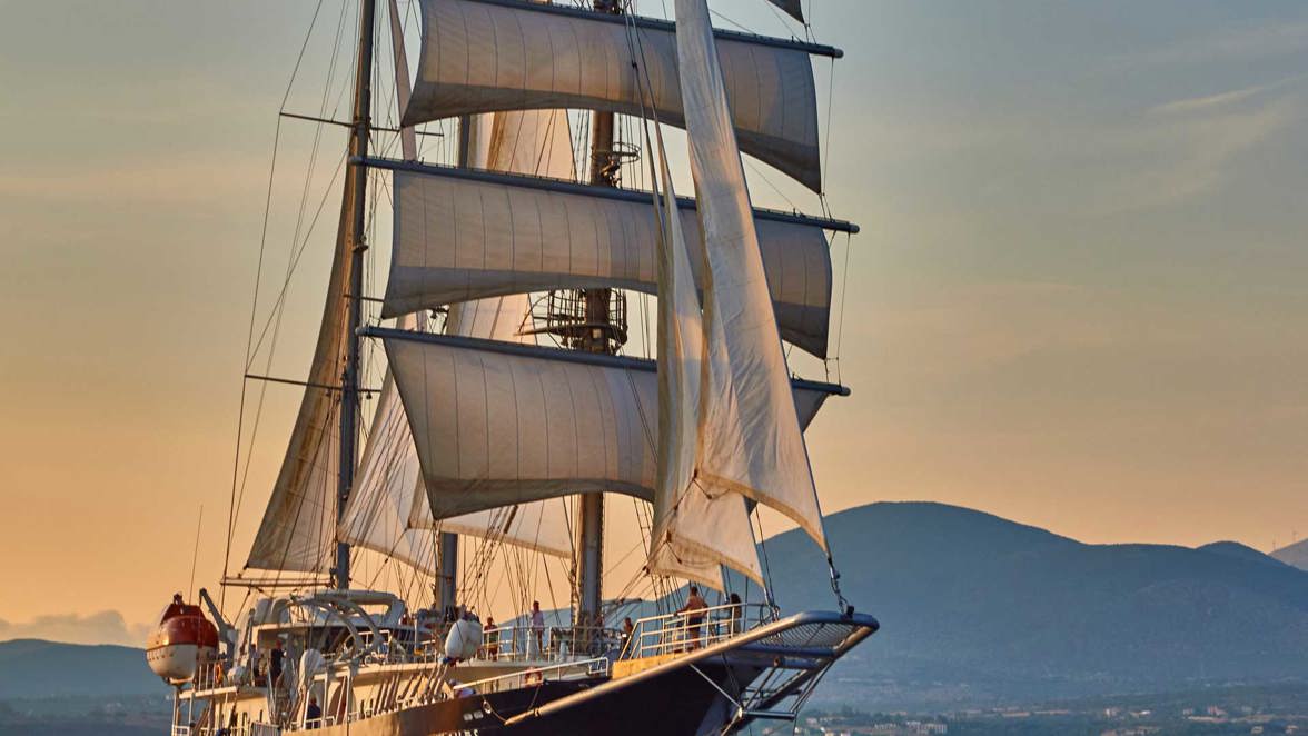 ship at full sails near island